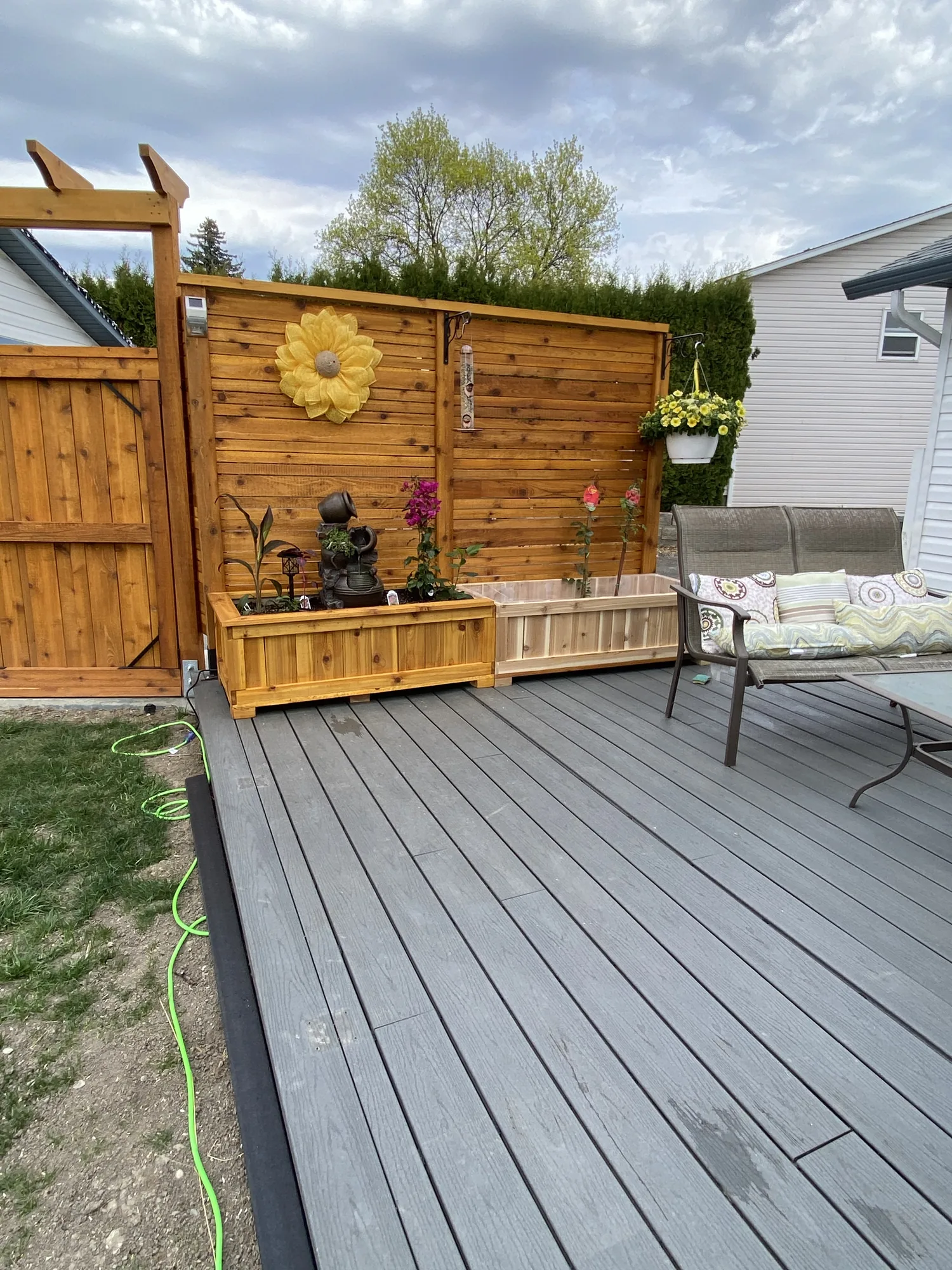 Cedar privacy screen with built-in planter on a deck