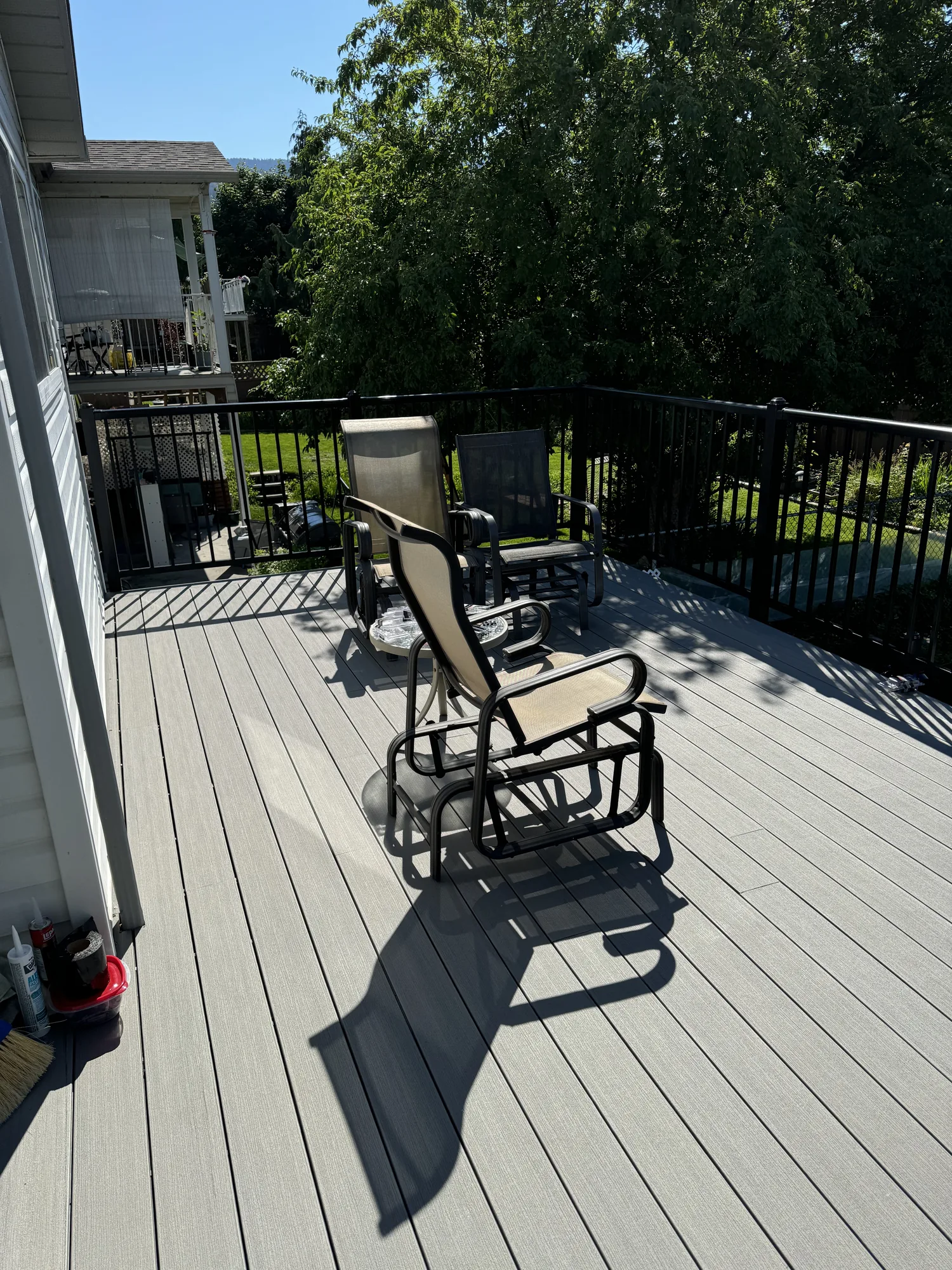 Finished grey composite deck with black aluminum railings in Kelowna