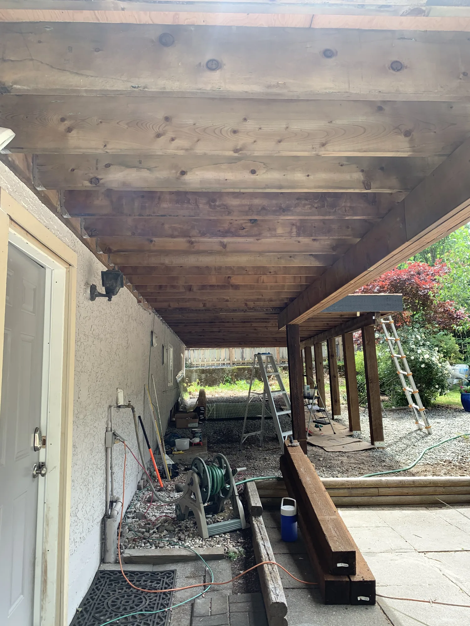 Deck teardown under a covered patio