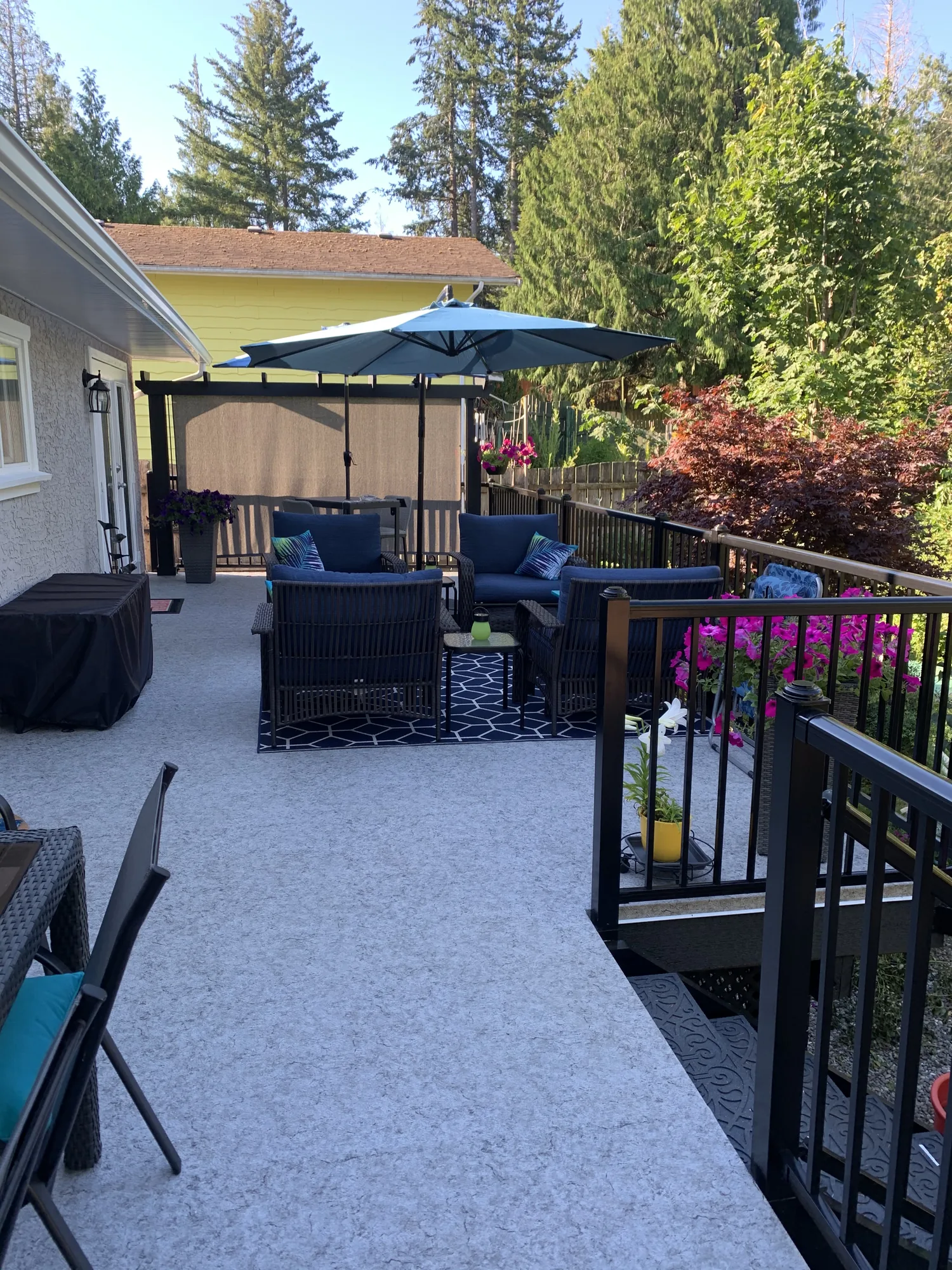 Finished patio and deck with black railing